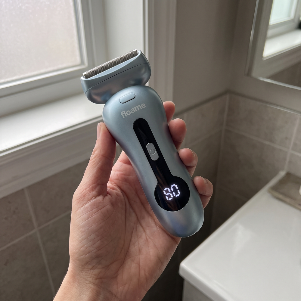 Hand holding the shaver showing the battery display